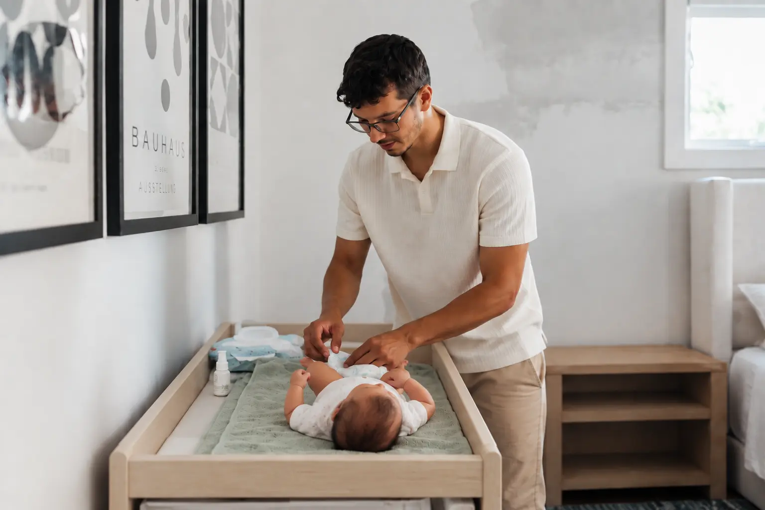 An adult cradling a baby at home