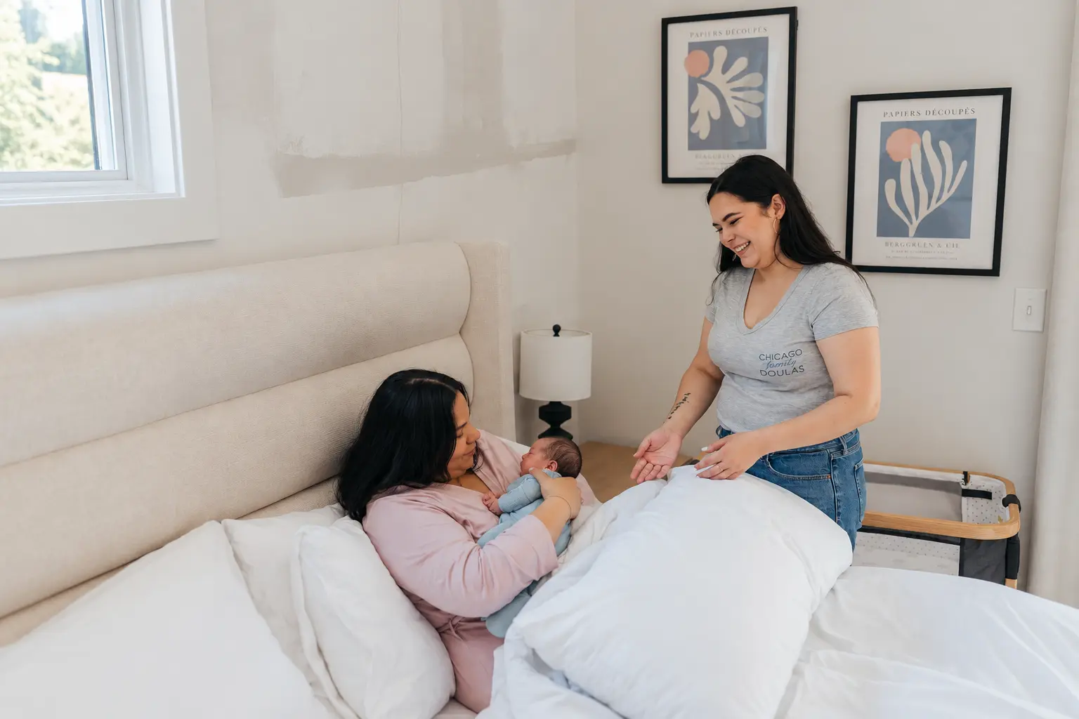 An adult holding a sleeping newborn close